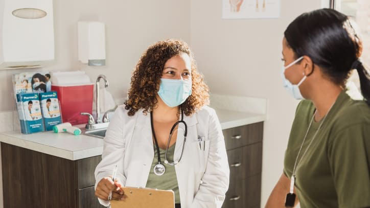 A doctor is talking to a patient in a doctor's office.