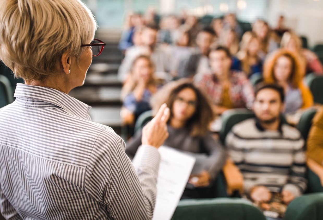 A professor teaching a class of students.