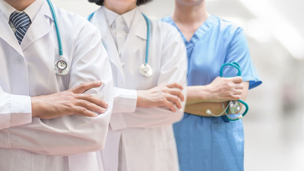 A group of doctors standing in a hallway.