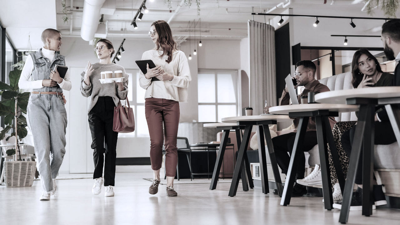 A group of people walking through an office.