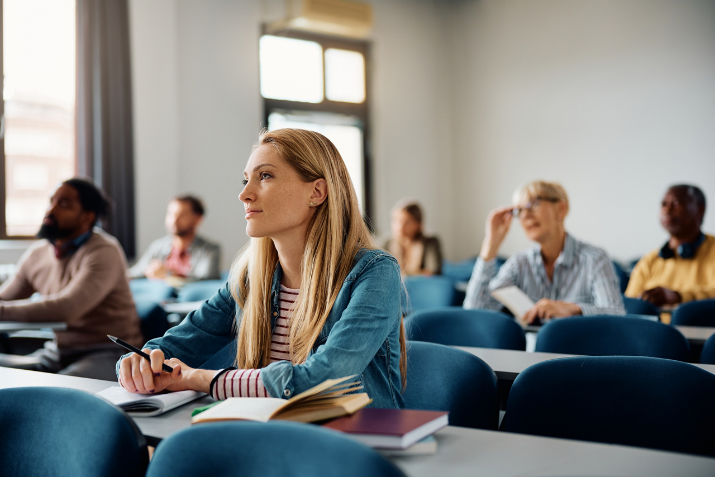 Woman sitting down at desk and listening 