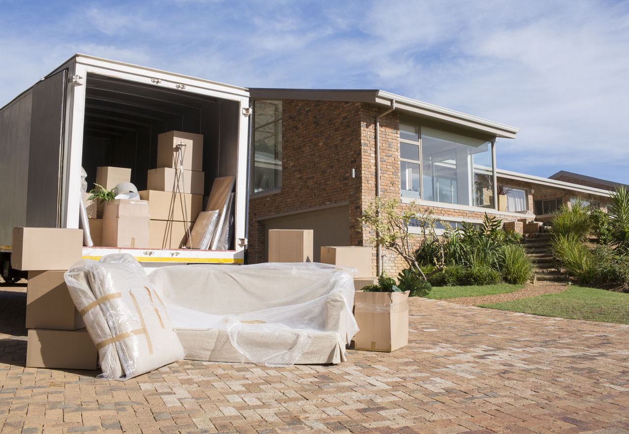 moving truck with packing items outside a single family  home