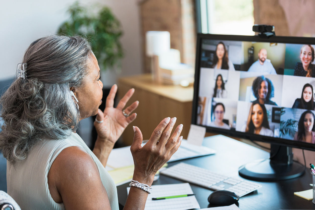 female colleague looking at screen during meeting with remote employees