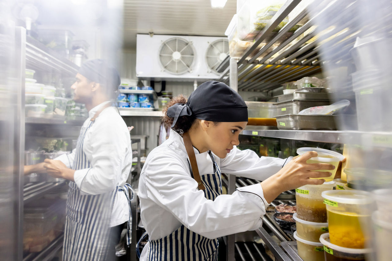 Restaurant workers in a kitchen.