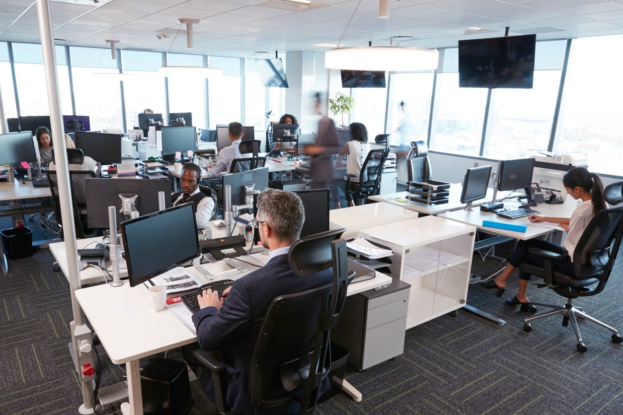 group of people working in an office at their desks