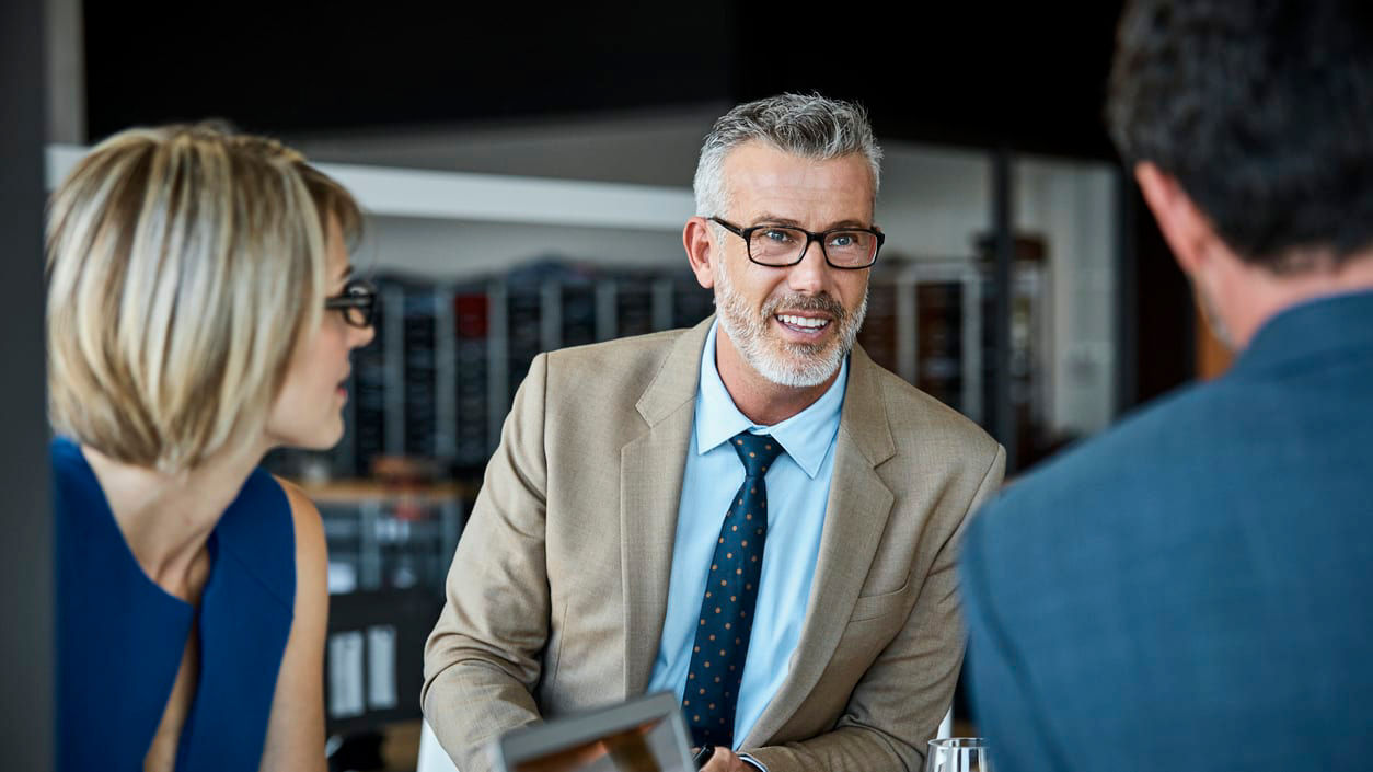 A group of business people having a meeting in a restaurant.