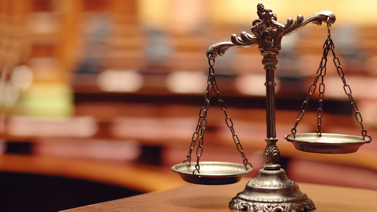 The scales of justice in a courtroom.