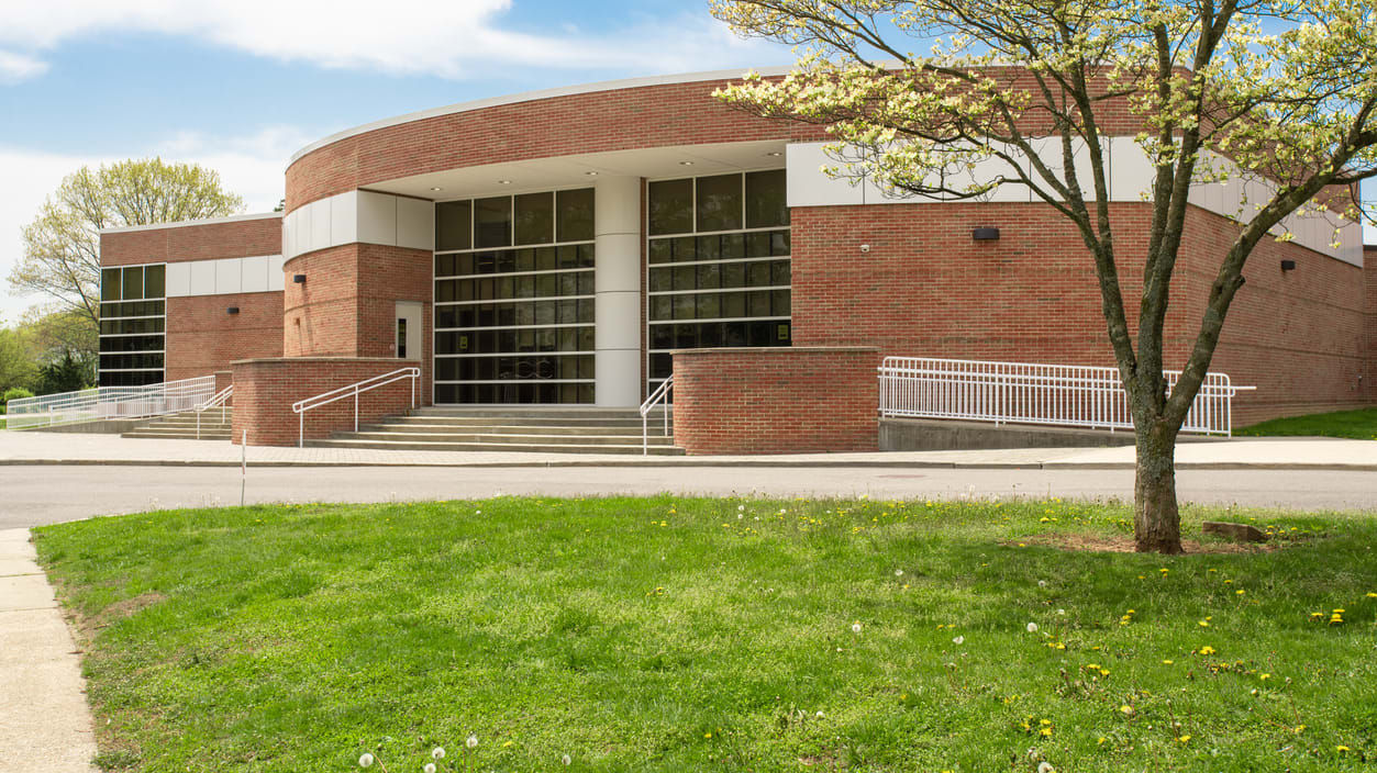 A brick building with a tree in front of it.