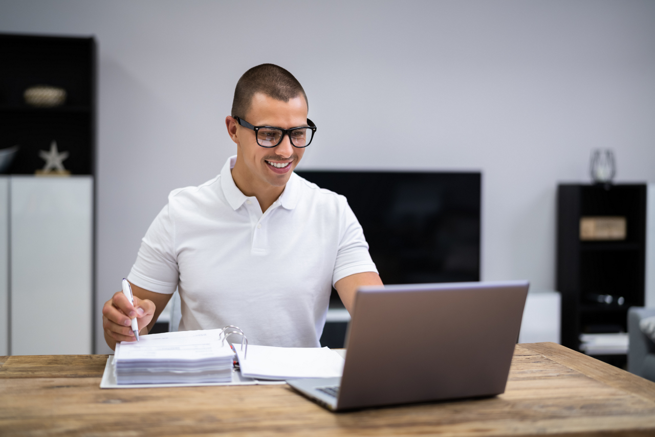 Happy Young Man Doing Taxes And Money Budget