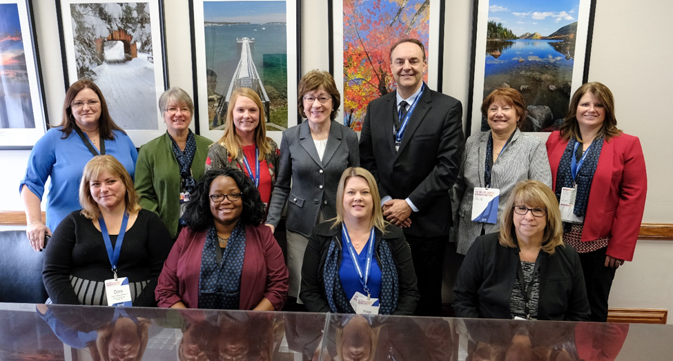 group of people meeting with senator Susan Collins