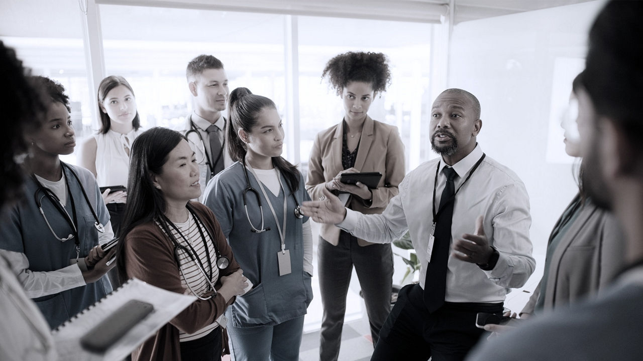 HR leader talking to his employees surrounding him