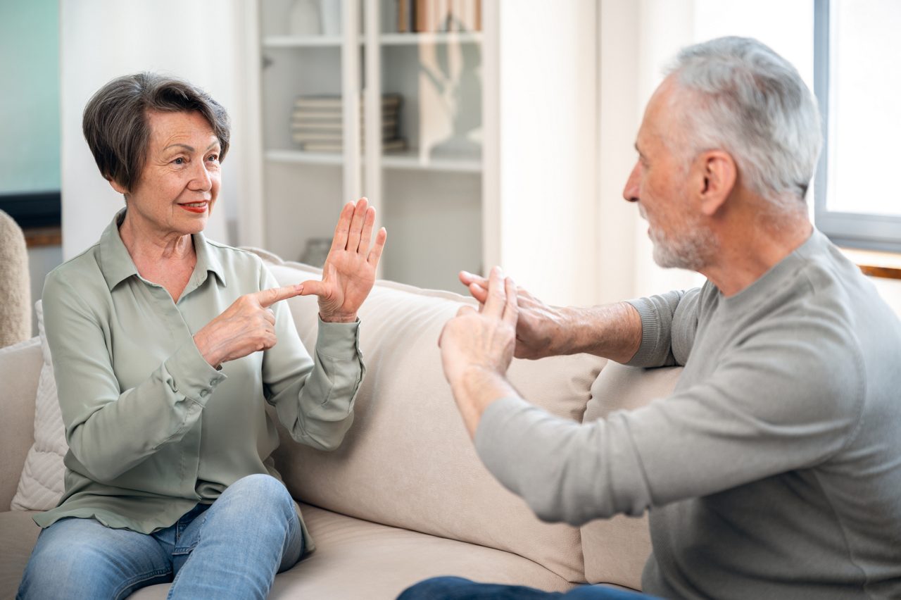 Two adults using sign language