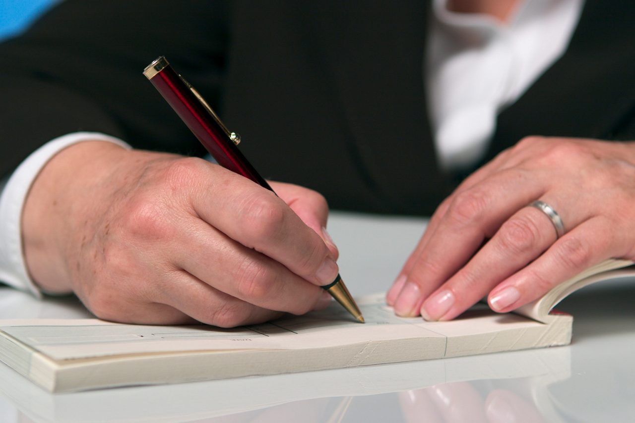 Person writing a check