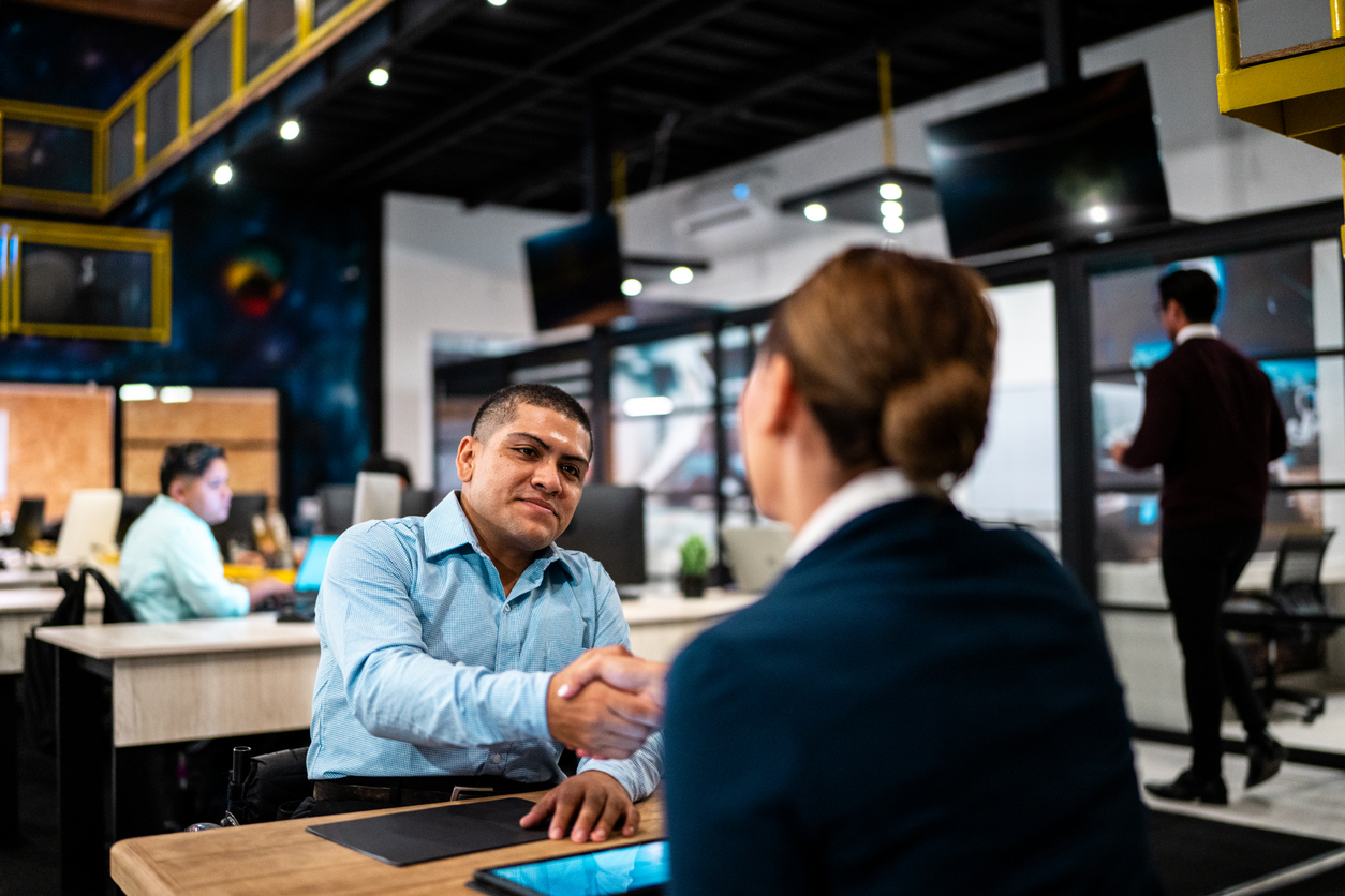 Recruiter and candidate greeting each other during interview job at office