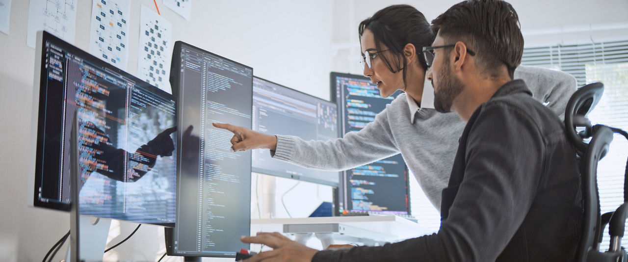 Hispanic Latin American couple, software engineer developer use computer, work on program coding together at home office. Programming language development technology, freelance job concept
