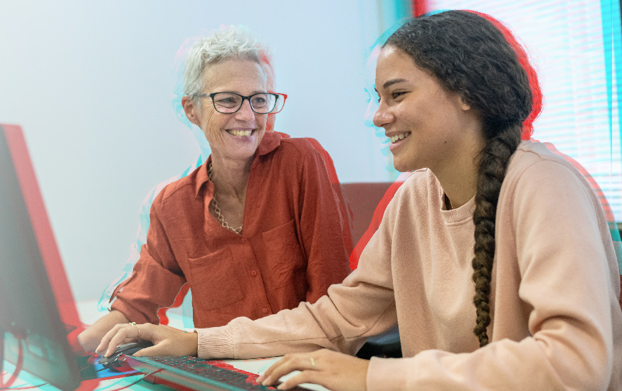 young woman smiling at desk