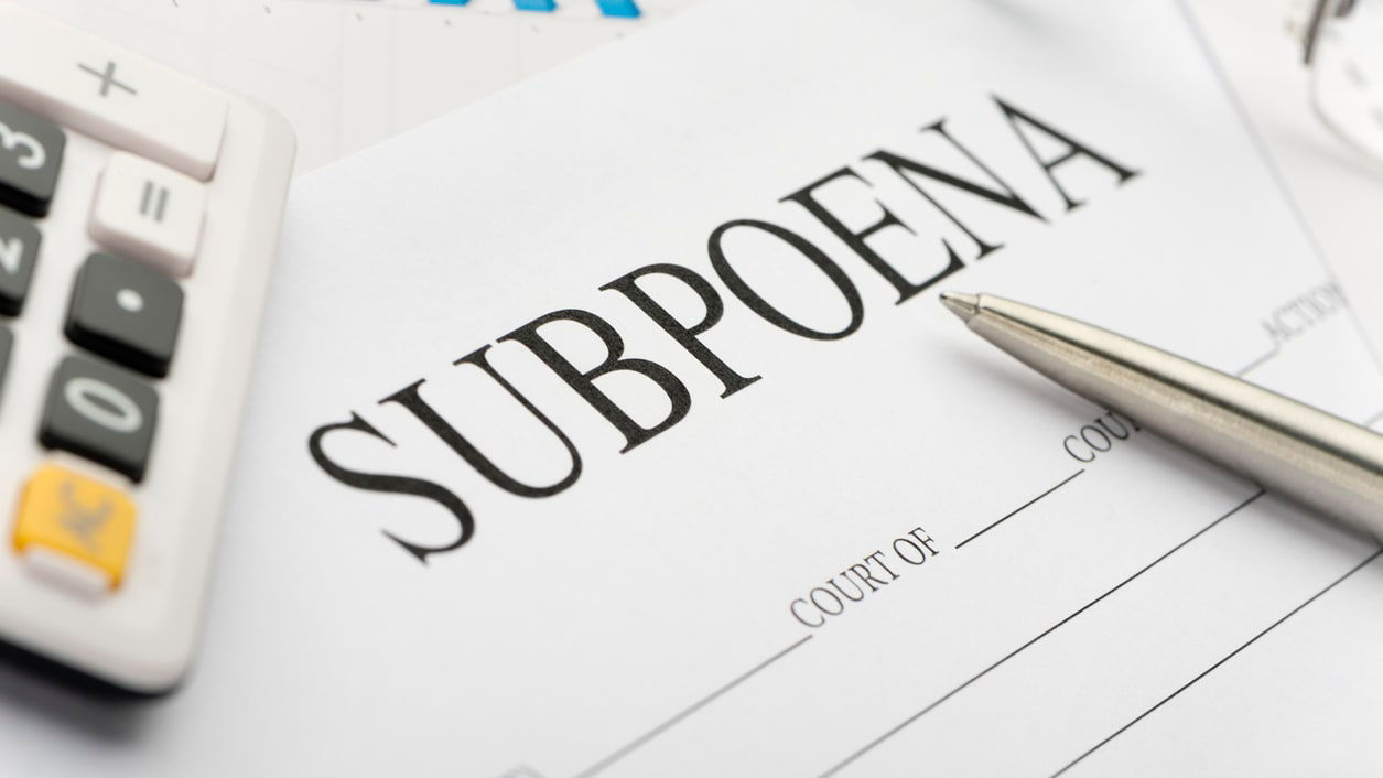 A paper with the word subpoena on it.
