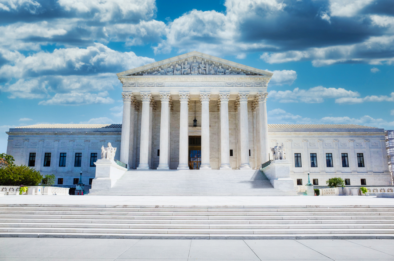 A photograph of the United States Supreme Court Building in Washington DC with darkening storm clouds.