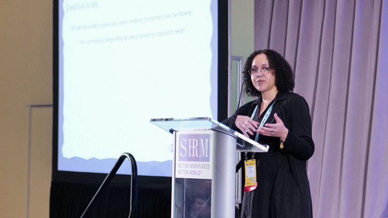 Sydney Ross on stage speaking at Talent26