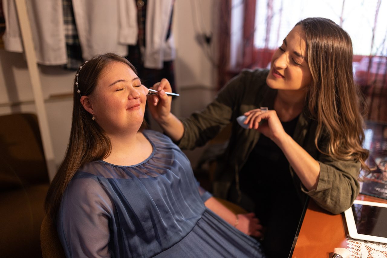 artist applying makeup to actor