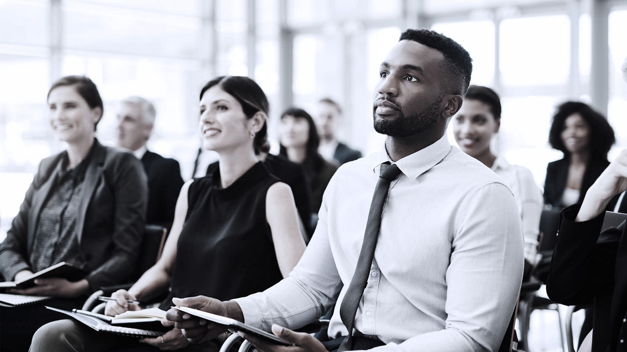 A group of business people sitting in a conference room.