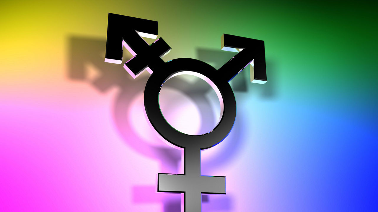 An image of a male and female symbol on a rainbow colored background.