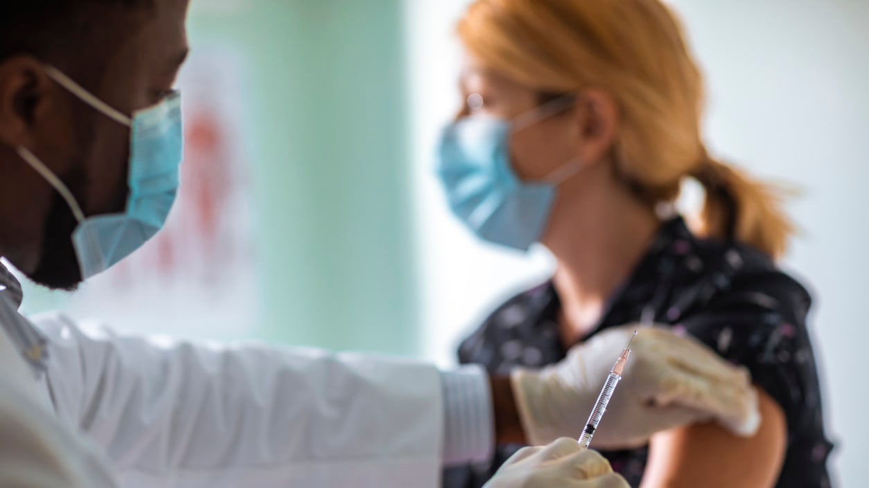 A doctor giving a vaccine to a patient.