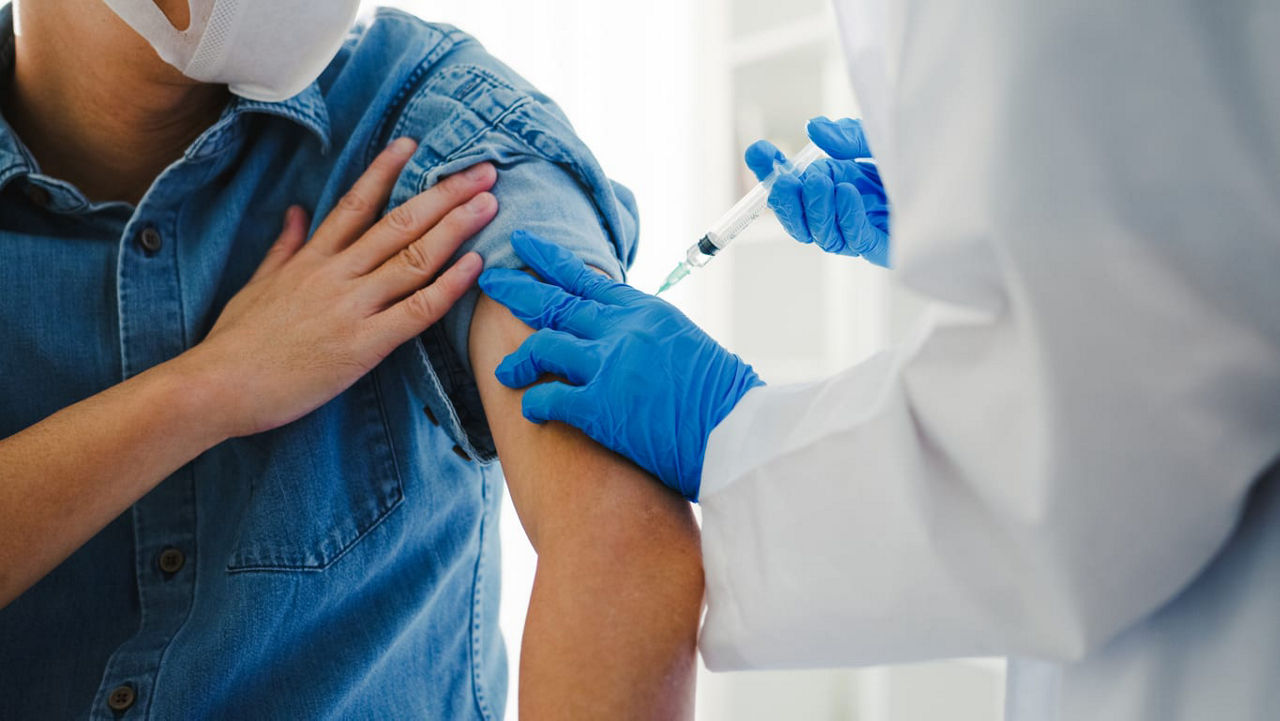 A doctor giving a vaccine to a patient.
