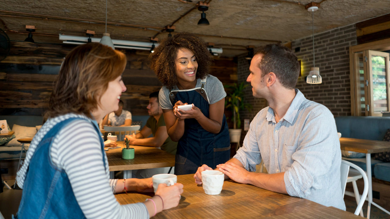 A group of people sitting at a table in a restaurant.