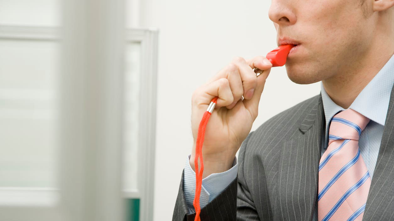 A man in a suit with a red tie.