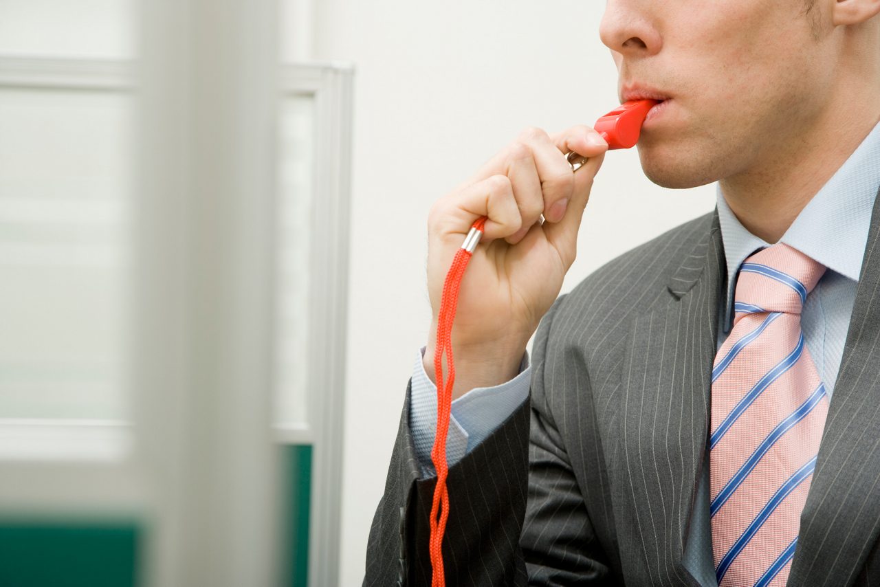 man blowing whistle