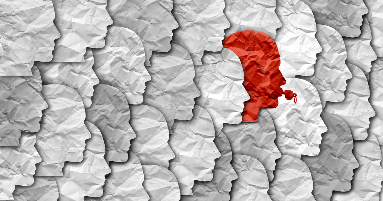 A graphic of the silhouettes of people's faces with one blowing a whistle.