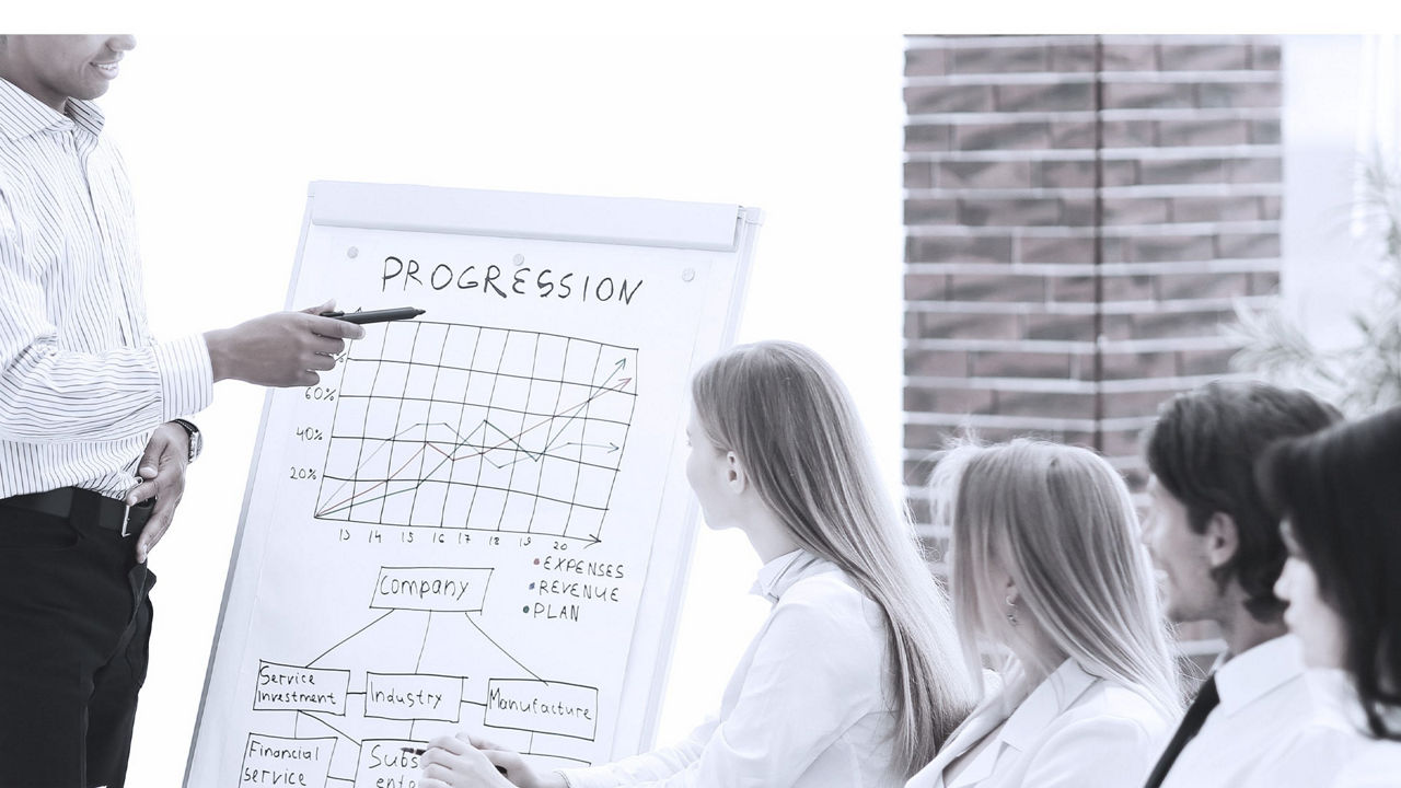 A man is giving a presentation to a group of people.
