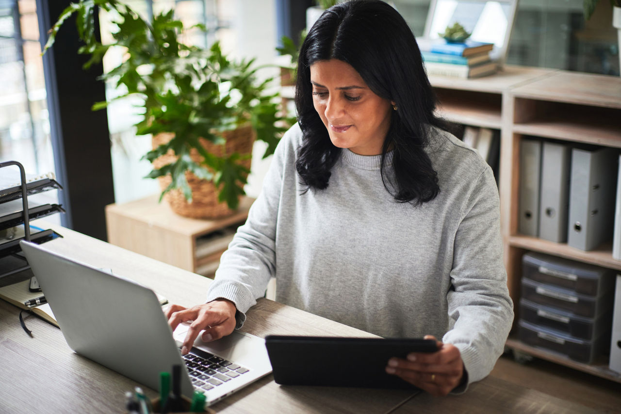 Tablet, laptop and business woman with online management, HR administration software and planning. Digital technology, computer and human resources person typing, search or payroll on company website