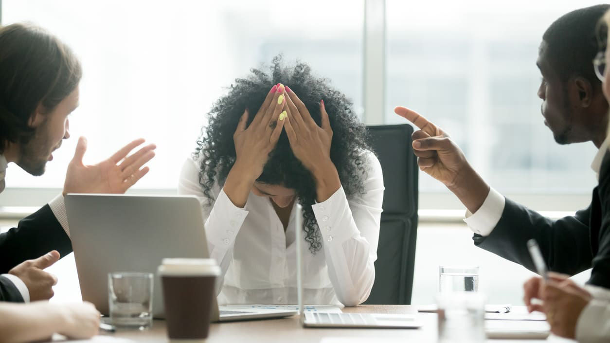 A group of people sitting around a table in a conference room.