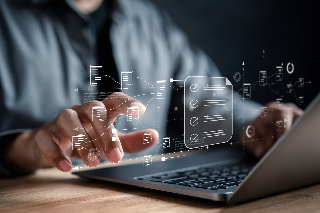 Businessman at computer with images symbolizing AI