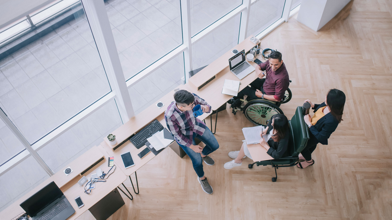 employees having conversation by desk