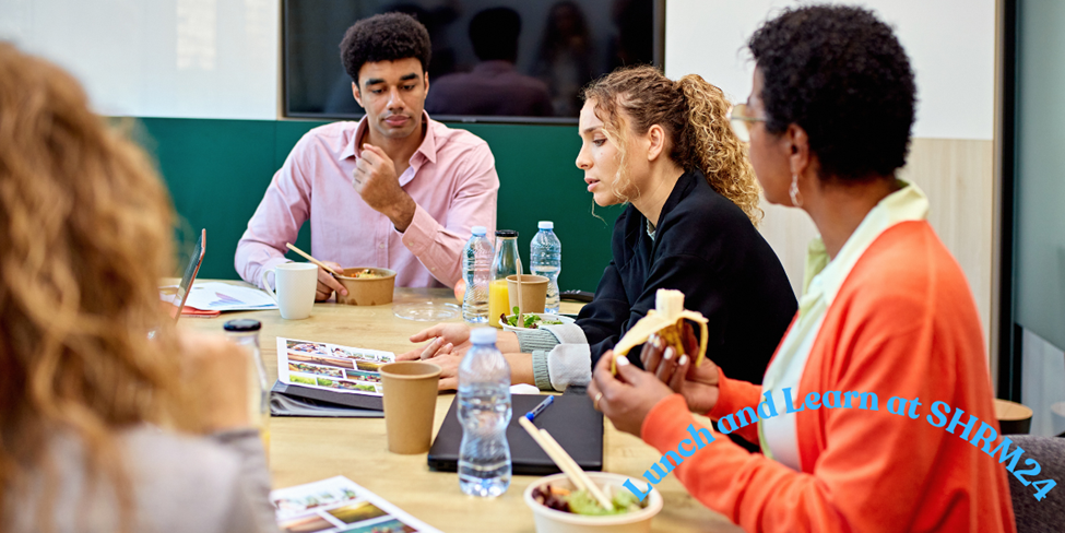 group of people sitting at a table during a working lunch