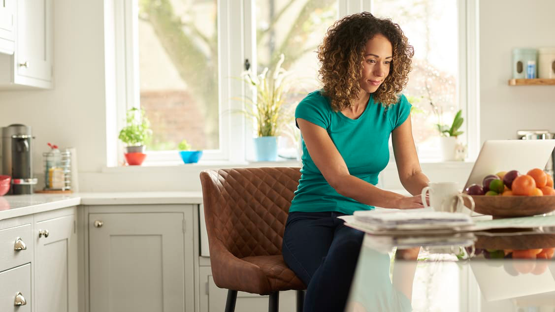lady working with a laptop in kitchen