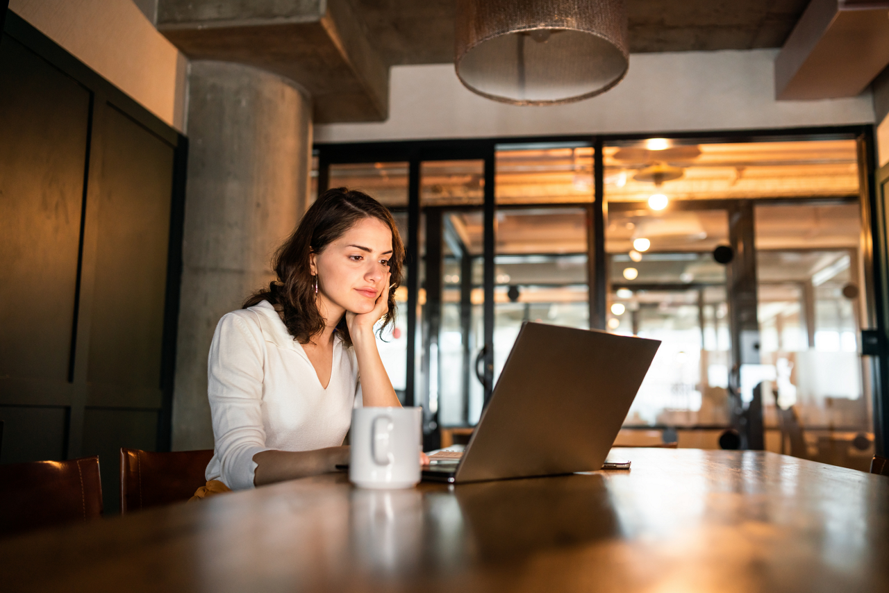 Young woman working on her laptop in office.