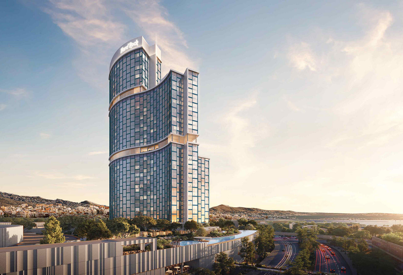 Modern curved glass skyscraper at sunset