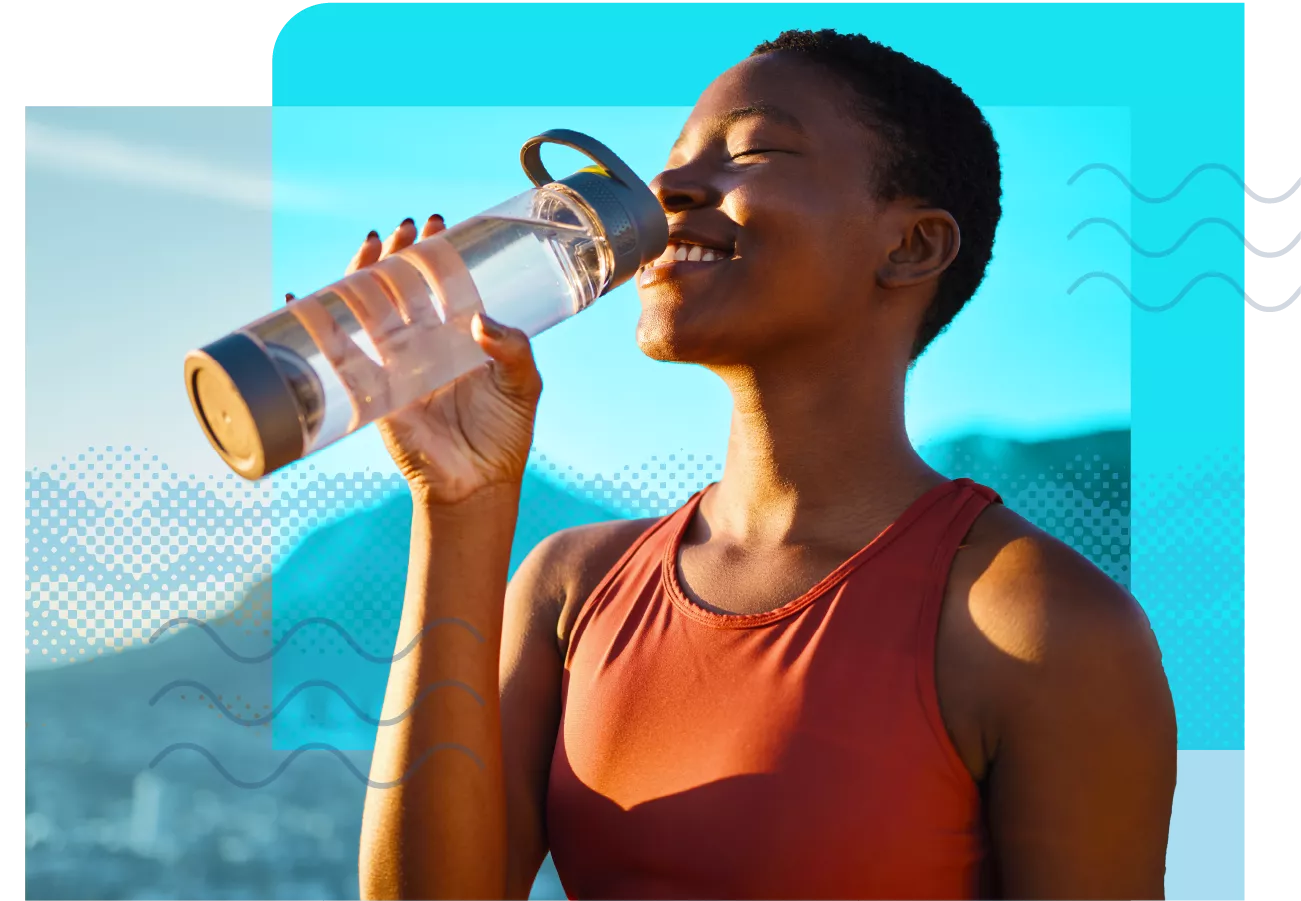 woman lifting up water bottle to drink