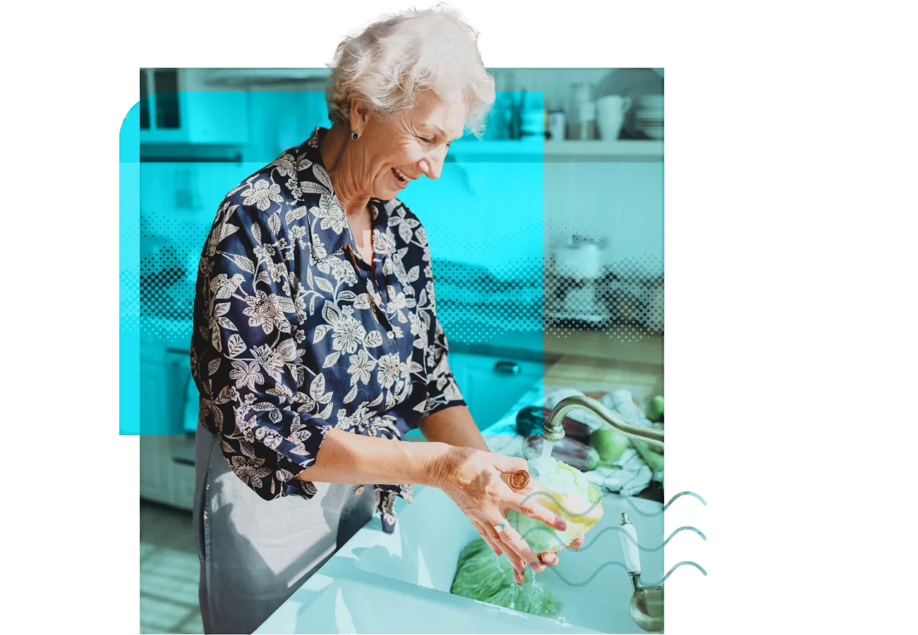 elderly woman smiling while filling a vase with water