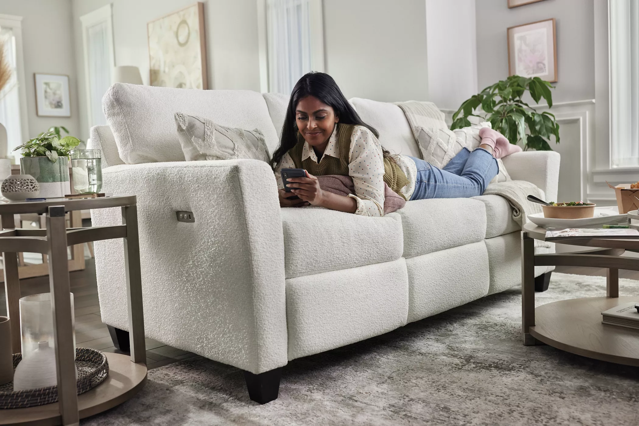 Woman relaxing on white modern sofa