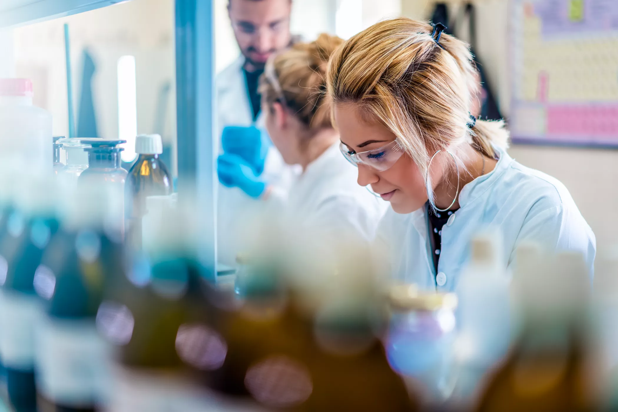 Beautiful young woman scientist in laboratory working. Young female scientist doing some research.