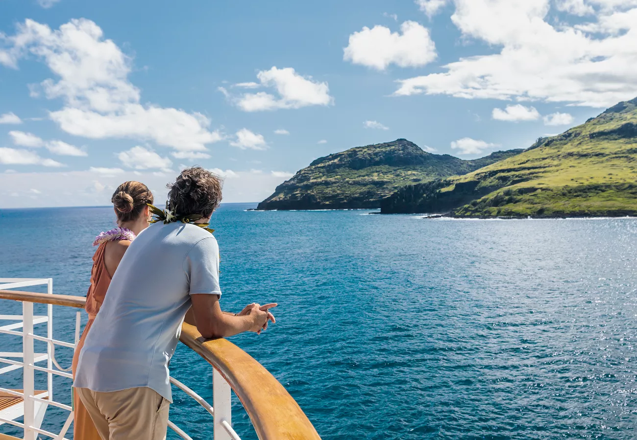 man and woman on a cruise liner looking at the view