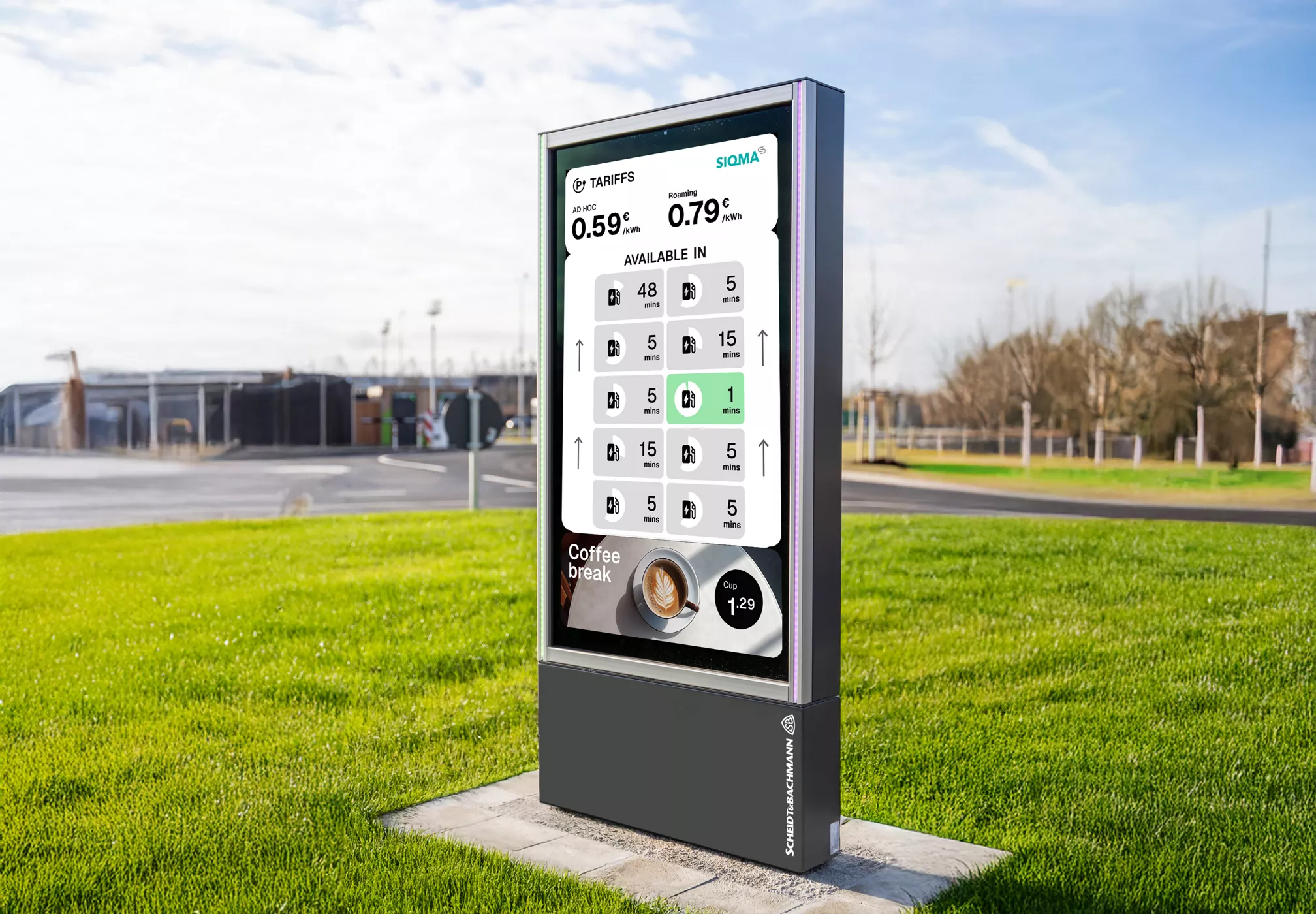 A modern digital menu board stands on a concrete base in a grassy outdoor area, displaying various beverage options and prices. The screen shows numeric values such as 0.59, 0.79, 1.29, and a selection grid with numbers like 5, 9, and 15. The background includes a parking lot and trees, suggesting a drive-thru or quick service restaurant environment. The display is clear and visually engaging, with a clean, contemporary design.