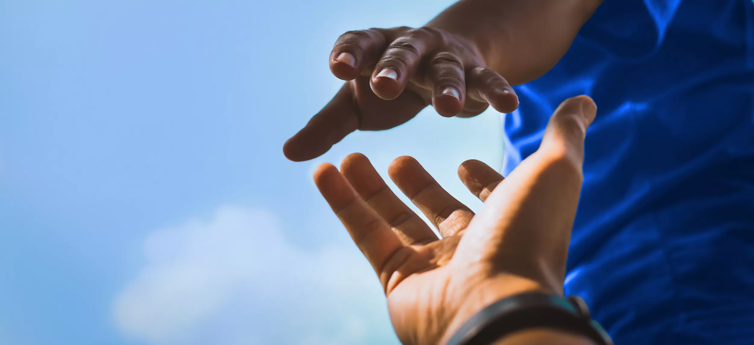 Help Concept hands reaching out to help each other in dark tone