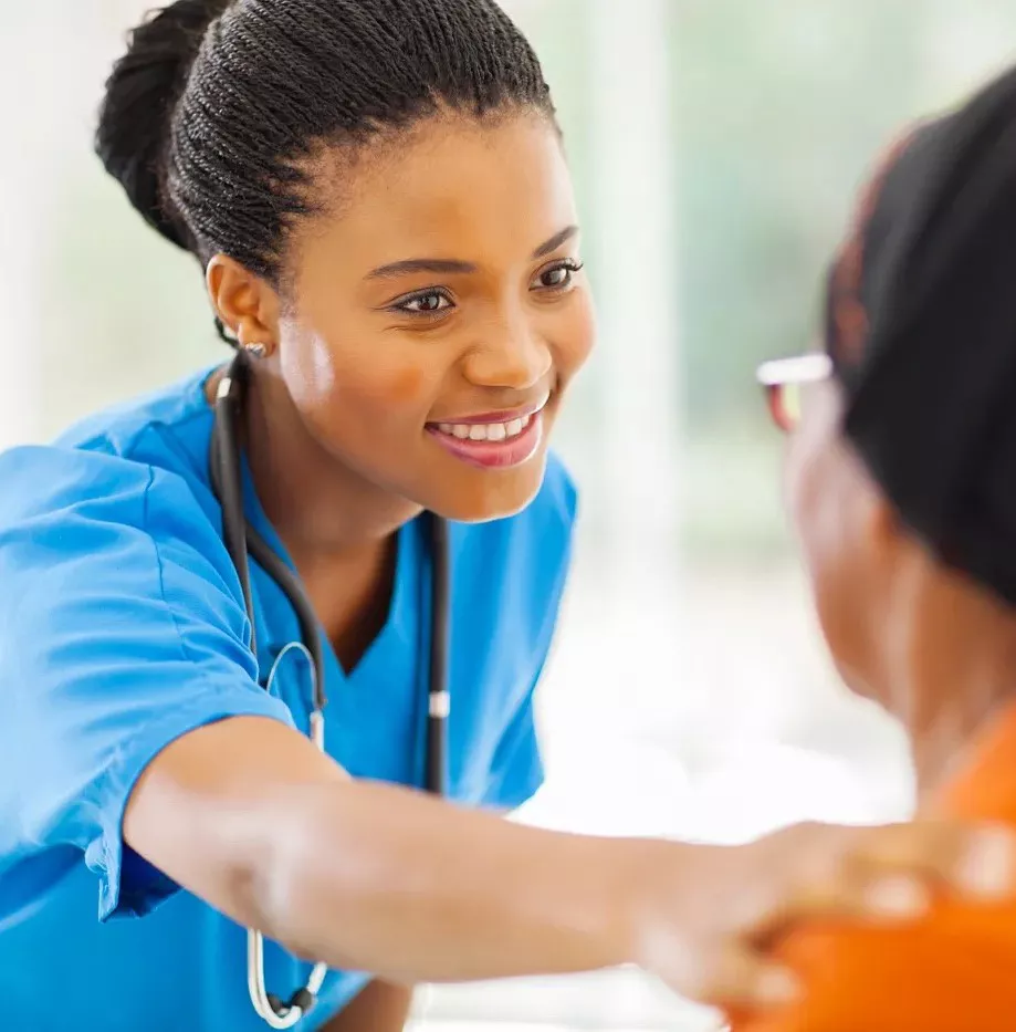 Nurse helping patient with hand on shoulder
