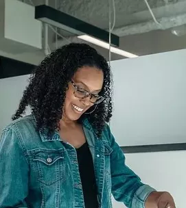 Coworkers standing and looking at paper